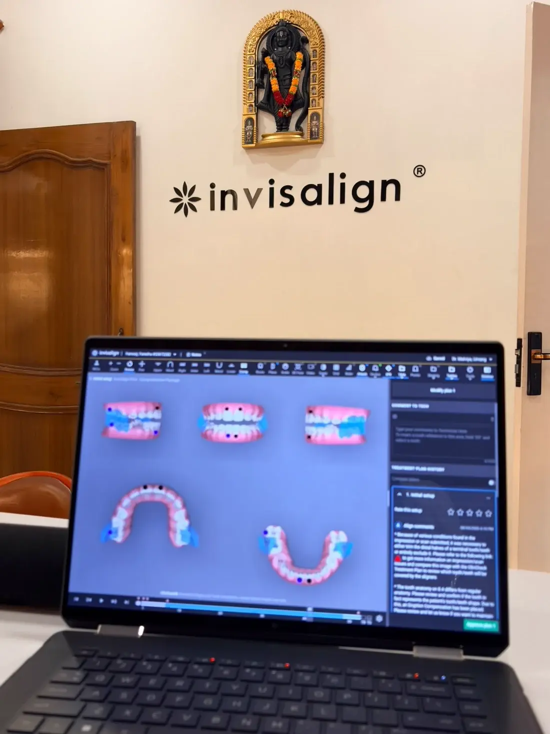 Invisalign ClinCheck treatment plan on screen beneath the Invisalign wall sign