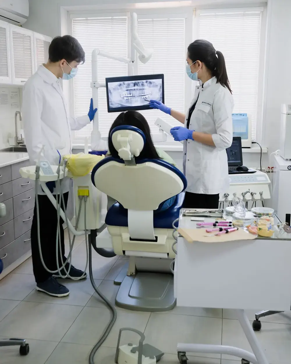 A dental team examining a patient before implant treatment