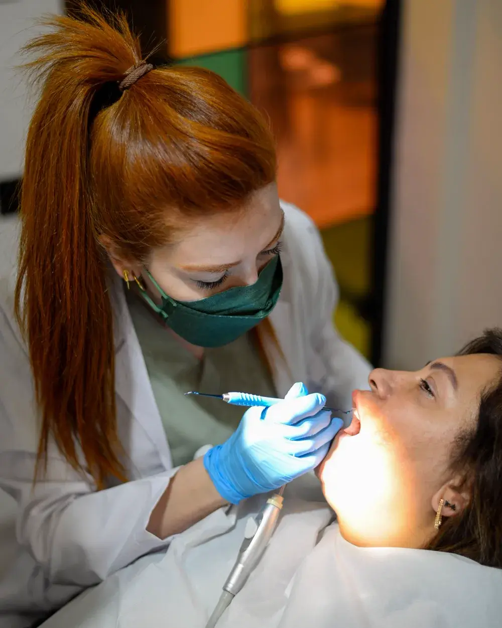 A dentist examining a patient's gums during a periodontal assessment