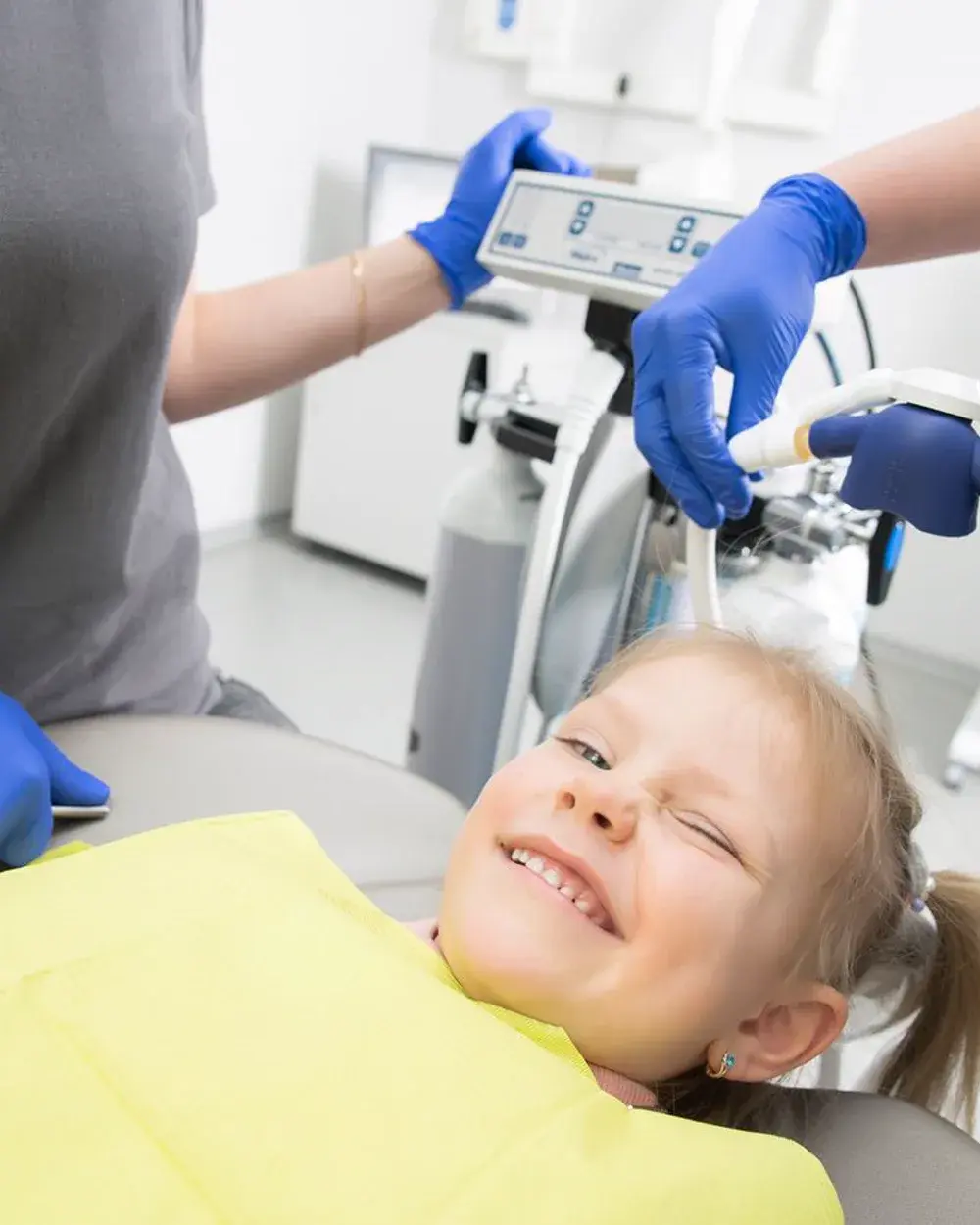 A smiling child in the dental chair during a check-up