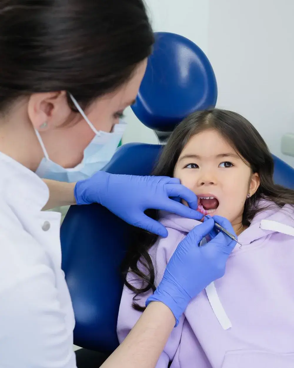 A dental professional carrying out a scaling and polishing clean