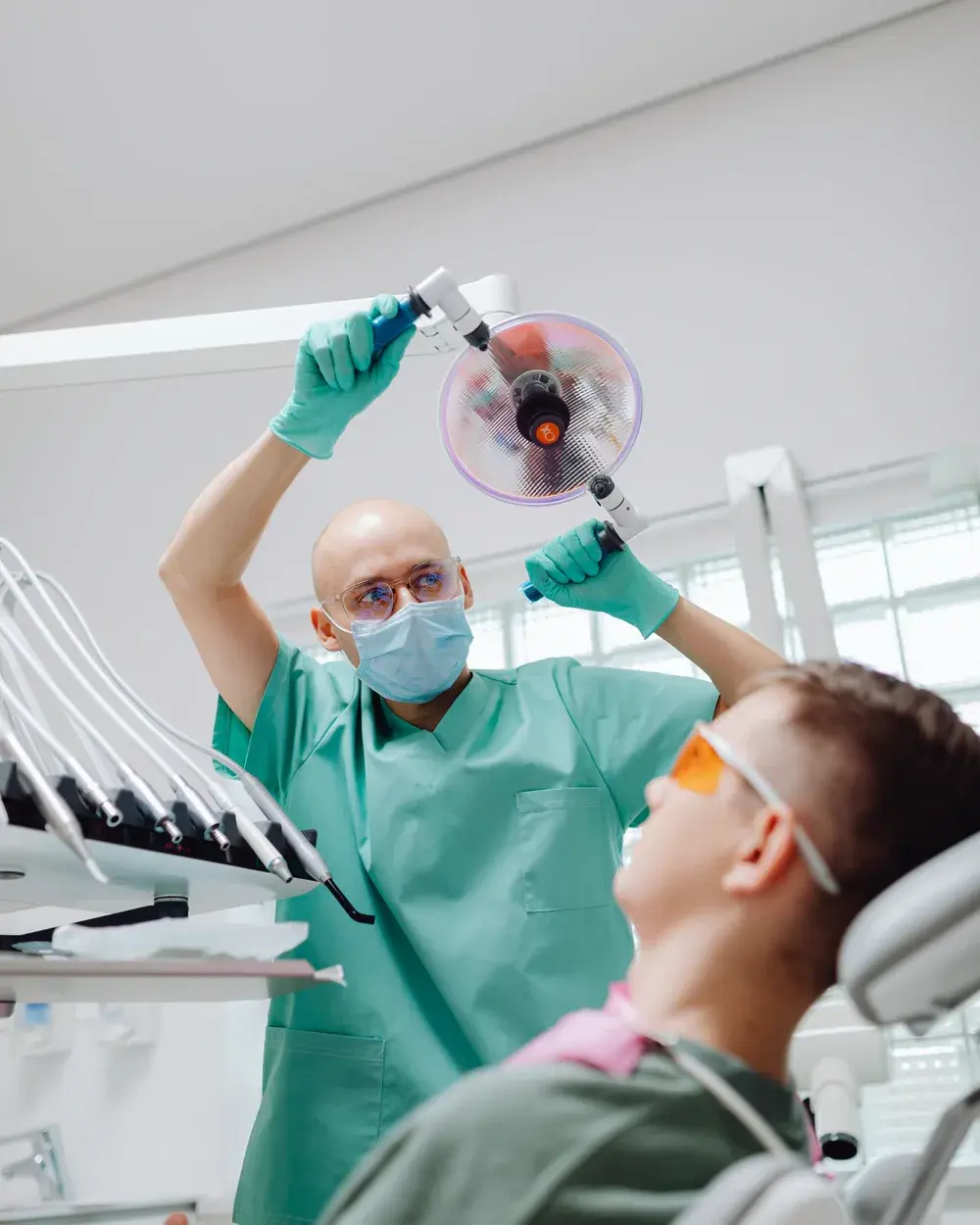 A dentist positioning the treatment light before placing a filling